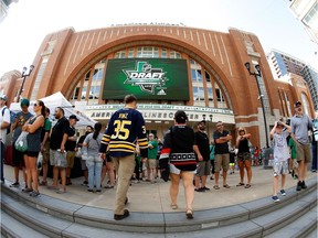 Fans look to enter the arena before the first round of the NHL draft in Dallas on Friday evening.