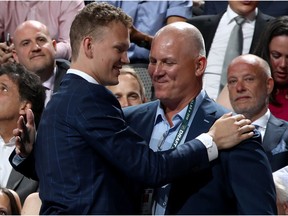 Brady Tkachuk receives a hug from his father, Keith, after being selected fourth overall by the Senators during the first round of the NHL Draft in Dallas on Friday evening.