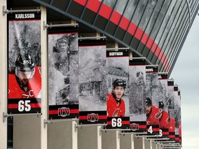 Storm clouds gathered over Canadian Tire Centre Wednesday (June 13, 2018), where images of teammates Erik Karlsson and Mike Hoffman hang together outside.