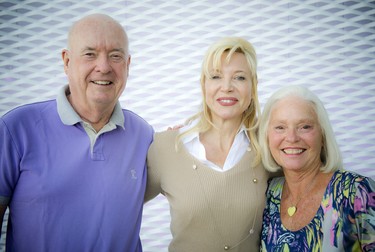 Glenn and Barbara McInnes, donors to the Ottawa Art Gallery, flank Alexandra Badzak, chief executive officer of the Ottawa Art Gallery.