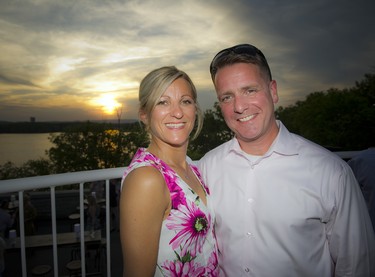 Anna and Mark Belanger stand in front of the setting sun.