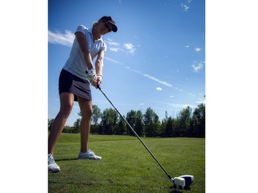 Kim Parker lines up to take a swing with a teed-up marshmallow.