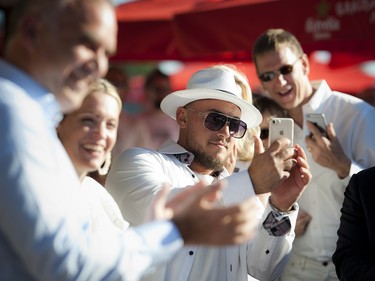 Dom Donato, one of the partners in Tavern on the Falls, takes a photo during the speeches.