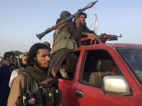 Taliban fighters ride in their vehicle in Surkhroad district of Nangarhar province, east of Kabul, Afghanistan, Saturday, June 16, 2018.