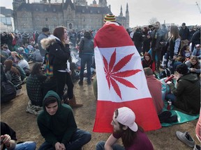A photo taken on April 20 shows a man wearing a Canadian maple leaf flag with marijuana leaf during the annual 4/20 rally on Parliament Hill.