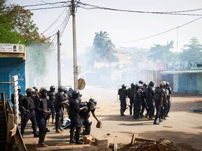 TOPSHOT - Malian anti-riot police officers arrive to control a demonstration against the lack of transparency of the presidential election's campaign, on June 2, 2018 in Bamako.