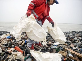 Groups of volunteers clean up plastic waste on a beach in Lima, during the World Environment Day on June 5, 2018. The UN urged to take steps against the use of plastic bags, as part of a global challenge to reduce the increasing pollution of the oceans.