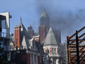 Firefighters tackle a blaze at the Mandarin Oriental hotel in central London on June 6, 2018. A fire broke out at London's Mandarin Oriental hotel, with dozens of firefighters deployed to tackle the blaze that pumped smoke high into the air over the British capital.