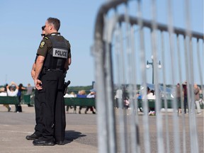 Police officers keep an eye on tourists near in Quebec City ahead of the G7 summit in nearby La Malbaie.