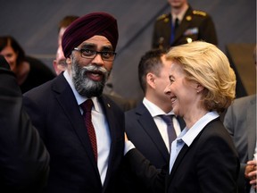 Defence Minister Harjit Singh Sajjan (L) talks with German Defence Minister Ursula von der Leyen (R) during a Defense Council meeting at the North Atlantic Treaty (NATO) headquarters in Brussels on June 7, 2018.