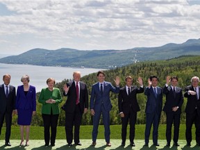 G7 leaders pose for the family photo during the G7 Summit on June 8, 2018 in La Malbaie, Canada. From left are:  European Council President Donald Tusk; British Prime Minister, Theresa May; German Chancellor, Angela Merkel; US President Donald J. Trump; Canadian Prime Minister, Justin Trudeau; French President Emmanuel Macron; Japanese Prime Minister, Shinzo Abe; Italian Prime Minister Giuseppe Conte; and European Commission President Jean Claude Juncker.