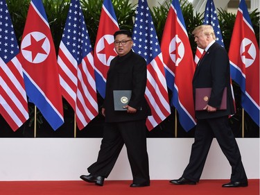 US President Donald Trump (R) walks out with North Korea's leader Kim Jong Un (L) after taking part in a signing ceremony at the end of their historic US-North Korea summit, at the Capella Hotel on Sentosa island in Singapore on June 12, 2018. Donald Trump and Kim Jong Un became on June 12 the first sitting US and North Korean leaders to meet, shake hands and negotiate to end a decades-old nuclear stand-off.