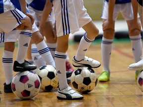 Elementary school children attending a kids soccer school class.