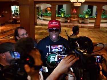 Retired American professional basketball player Dennis Rodman speaks to the press from the Regent hotel following the US-North Korea summit in Singapore on June 12, 2018.  US President Donald Trump has formed a "special bond" with North Korea's leader Kim Jong Un, he said on June 12, at the end of a historic meeting during which the two former foes pledged to meet again.
