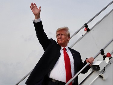 This handout photo taken on June 12, 2018 and released by the Ministry of Communications and Information of Singapore shows US President Donald Trump waving goodbye as walks up the stairs to Air Force One at Paya Lebar Air Base upon departure following the US-North Korea summit in Singapore. Kim Jong Un and Donald Trump will meet on June 12 for an unprecedented summit in an attempt to address the last festering legacy of the Cold War, with the US president calling it a "one time shot" at peace.