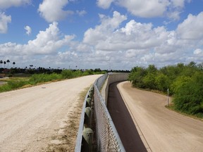A wall along one of the several layers of the US-Mexico border fencing in the border town of McAllen, Texas on June 14, 2018.