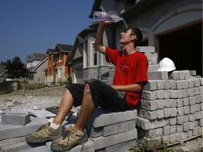 A onstruction worker Alexander Gora tries to cool off as the heat wave continues in Ottawa Wednesday.