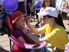 Amelia Belcher gets her face painted by Breanna Lefebvre-Brisson just before the ALS Walk on Saturday June 2, 2018 in Cornwall, Ont.