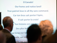 The words to O Canada are projected on a screen during a national Conservative caucus in Victoria, B.C. In its French version the anthem contains Christian imagery and invokes “valour steeped in faith.”