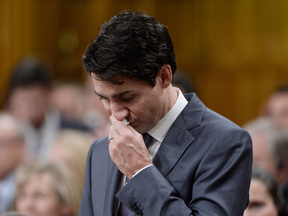 Prime Minister Justin Trudeau pauses while making a formal apology to individuals harmed by federal legislation, policies, and practices that led to the oppression of and discrimination against LGBTQ2 people in Canada, in the House of Commons, Nov.28, 2017.