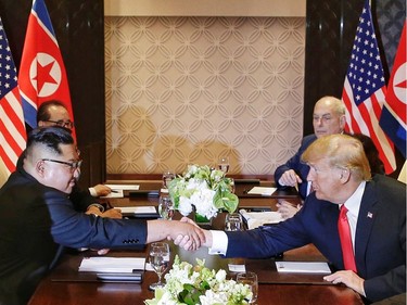 U.S. President Donald Trump shakes hands with North Korean leader Kim Jong Un during their meeting at the Capella resort on Sentosa Island Tuesday, June 12, 2018, in Singapore. (Kevin Lim/The Straits Times via AP) ORG XMIT: BKWS305