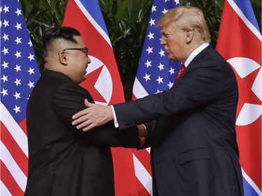 U. S. President Donald Trump shakes hands with North Korea leader Kim Jong Un at the Capella resort on Sentosa Island Tuesday, June 12, 2018 in Singapore.