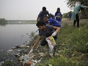 Volunteers clean the banks of Yamuna, India's sacred river that flows through New Delhi, Tuesday, June 5, 2018. World Environment Day is observed during June 5. This year the theme is "Beat Plastic Pollution".