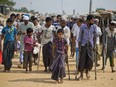 In this April 29, 2018 file photo, wounded Rohingya refugees await the arrival of a U.N. Security Council team at the Kutupalong Rohingya refugee camp in Kutupalong, Bangladesh.