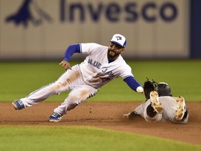 Toronto Blue Jays second baseman Devon Travis (29) makes the catch from Jays catcher Russell Martin (55) as New York Yankees shortstop Didi Gregorius (18) is caught stealing second during ninth inning American League baseball action in Toronto on Wednesday, June 6, 2018.