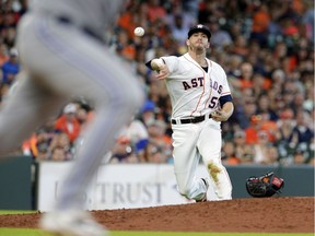After getting hit on the the grounder by Blue Jays' Aledmys Diaz, Houston Astros relief pitcher Ken Giles (53) fields the ball to first base during the eighth inning of a baseball game Wednesday, June 27, 2018, in Houston.