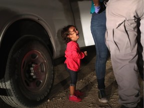 MCALLEN, TX - JUNE 12:  A two-year-old Honduran asylum seeker cries as her mother is searched and detained near the U.S.-Mexico border on June 12, 2018 in McAllen, Texas. The asylum seekers had rafted across the Rio Grande from Mexico and were detained by U.S. Border Patrol agents before being sent to a processing center for possible separation. Customs and Border Protection (CBP) is executing the Trump administration's "zero tolerance" policy towards undocumented immigrants. U.S. Attorney General Jeff Sessions also said that domestic and gang violence in immigrants' country of origin would no longer qualify them for political asylum status.