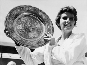 This file photo from 1959 shows Maria Bueno of Brazil holding the trophy after winning the Wimbledon women's singles final. The Brazilian who won three Wimbledon and four U.S. championship singles titles died Friday in Sao Paulo. AP Photo, File