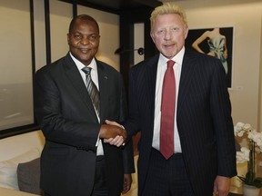 FILE - In this file photo originally released on Friday, April 27, 2018, President Prof. Faustin Archange Touadera, left, shakes hands with retired German tennis star Boris Becker in Brussels, Belgium, after it was announced Becker has been appointed by the Central African Republic as its Attache for Sports and Humanitarian and Cultural Affairs in the European Union with immediate effect. Lawyers for Becker claimed in Britain's High Court late Thursday June 14, 2018, that Becker's role as a sports attache for the Central African Republic gives him diplomatic immunity from bankruptcy proceedings.  (Irle Moser Rechtsanwalte PartG via AP Images, FILE) ORG XMIT: LON101