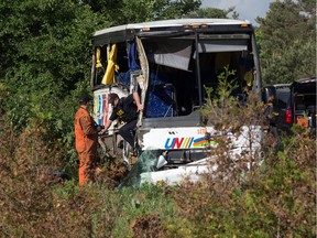 Police investigators on scene of the bus involved in the crash on the 401 west of Prescott. Photo by Wayne Cuddington/ Postmedia