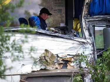 Inspectors at the scene of the bus crash on the 401 west of Prescott. Photo by Wayne Cuddington/ Postmedia