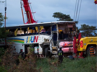 Tow trucks at the scene of the bus crash on the 401 west of Prescott. Photo by Wayne Cuddington/ Postmedia