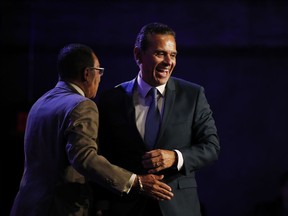 Former Los Angeles Mayor Antonio Villaraigosa, right, a candidate for California governor, is hugged by Los Angeles City Council President Herb Wesson at a primary-night watch party Tuesday, June 5, 2018, in Los Angeles.
