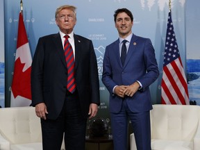 U.S. President Donald Trump meets with Canadian Prime Minister Justin Trudeau at the G-7 summit, Friday, June 8, 2018, in Charlevoix, Canada.