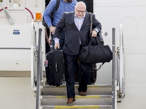 Washington Capitals head coach Barry Trotz arrives with the team at Dulles International Airport in Sterling, Va., Friday, June 8, 2018, the day after defeating the Vegas Golden Knights in Game 5 of the NHL hockey Stanley Cup Finals. (AP Photo/Andrew Harnik)