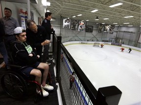 Philadelphia Flyers assistant general manager Chris Pryor, centre, talks with Ryan Straschnitzki at the Skate Zone, the team's practice facility, on Friday.