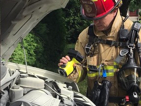 Fire lieutenant checks for spread after a cleaning van caught fire in OFS information officer Danielle Cardinal's driveway.