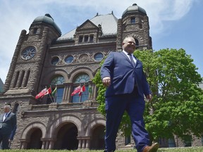Ontario premier-elect Doug Ford walks out onto the front lawn of the Ontario Legislature at Queen's Park in Toronto on Friday, June 8, 2018. Doug Ford started his first day as Ontario’s premier designate Friday much as he ran his campaign over the last four weeks, with the media held physically at bay, taking few questions and revealing relatively little about his plans.