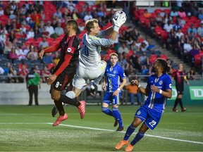 Independence goalkeeper Andrew Dykstra (50) pulls the ball in despite pressure from Steevan Dos Santos of Fury FC during Saturday's match at TD Place stadium.  Steve Kingsman/Freestyle Photography/Ottawa Fury FC