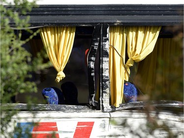 The side of a tour bus that was involved in a crash on Highway 401 West shows missing glass and signs of abrasion, near Prescott, Ont. on Monday, June 4, 2018.