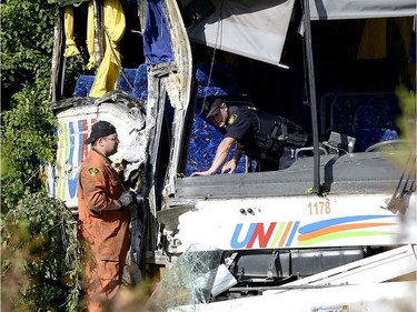 OPP officers work at the site of a crash involving a tour bus on Highway 401 West, near Prescott, Ont. on Monday, June 4, 2018. At least 24 people are in hospital, four with life-threatening injuries, after a bus crash in eastern Ontario, provincial police said Monday.