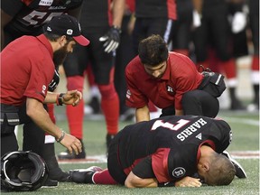 Redblacks medical staff attend to quarterback Trevor Harris after he was hit from behind during Thursday's pre-season game against the Alouettes at TD Place stadium.