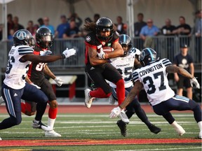 Redbacks kick returner Kieran Duncan tries to elude Argonauts defensive back Anthony Covington during CFL preseason football action in Guelph on Thursday night.