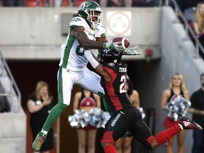 Redblacks defensive back Corey Tindal (28) prevents Roughriders receiver Naaman Roosevelt (82) from catching a pass in the end-zone in the first half of Thursday's game.