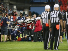 Argos QB Ricky Ray receives medical attention after being injured in the third quarter of Saturday's game against the Stampeders.