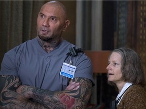 This image released by Global Road Entertainment shows Dave Bautista, left, and Jodie Foster in a scene from "Hotel Artemis."